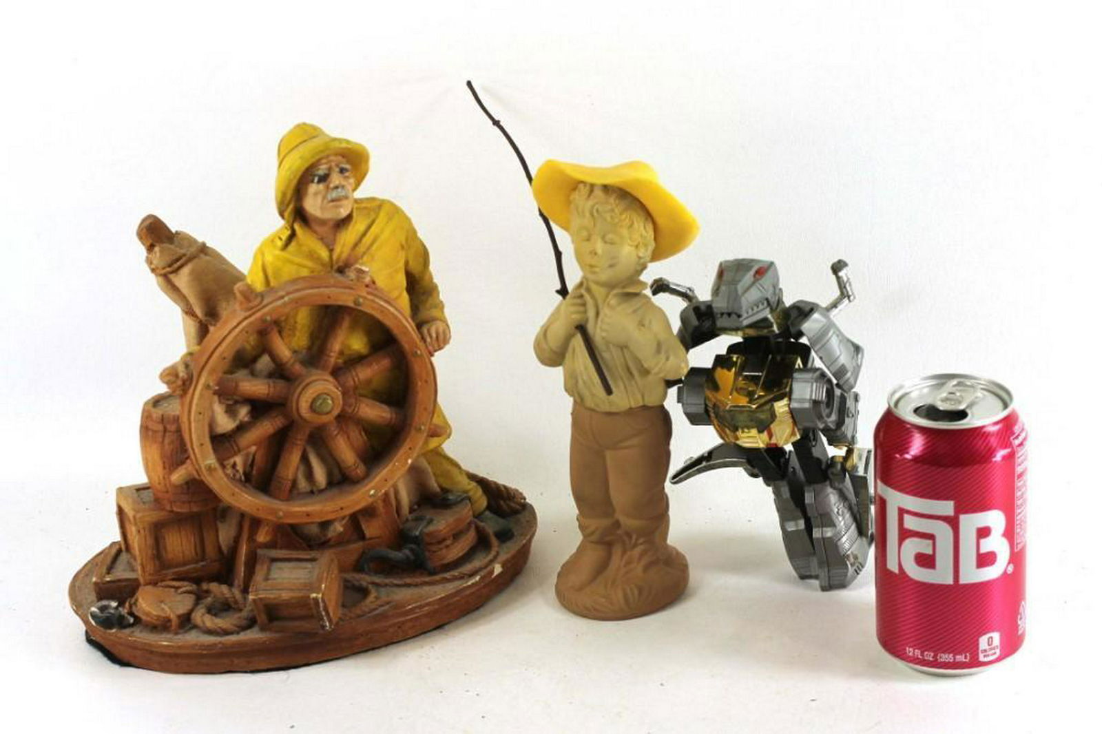 Misc Lot incl Action Figure and 2 Fishermen Figurines: Action figure dinosaur transforms into a robot plus 2 ceramic fishermen Condition: Larger fisherman has some chips