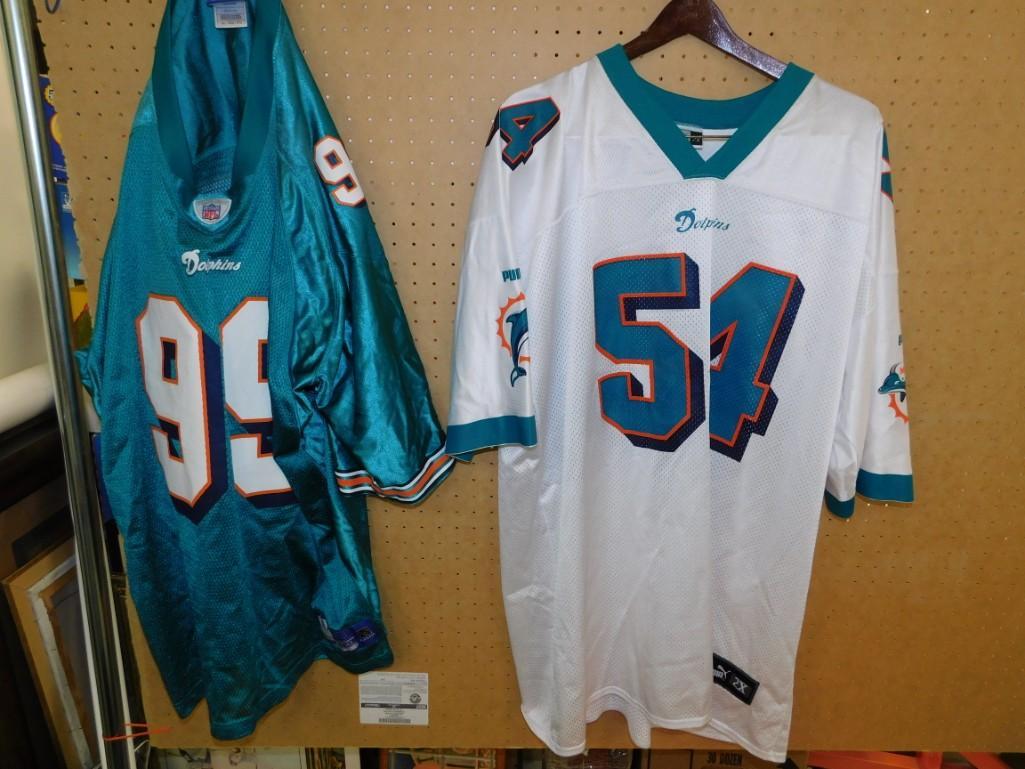 Lot of 2 Miami Dolphins Football Jerseys: Lot of 2 Miami Dolphins Football Jerseys Wozniak #99 and Z. Thomas #54 White Jersey is size 2X and is a Puma Other one is 3XL and is a Reebok 