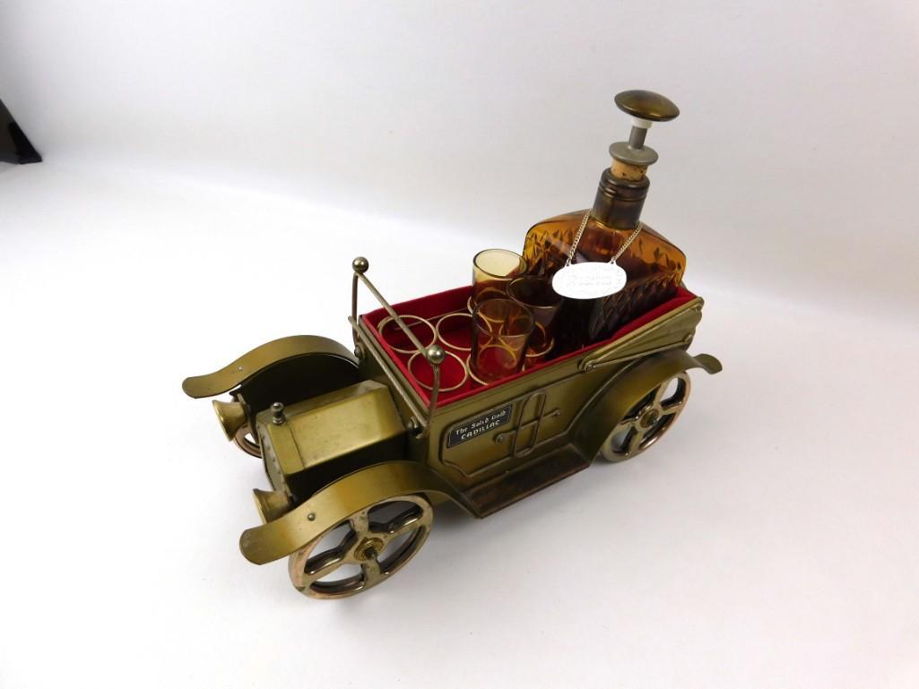 Musical Car Barware Set "The Solid Gold Cadillac": Musical Car Barware Set commemorating the movie "The Solid Gold Cadillac" . This is a music box that you wind by turning the wheel. The music plays when you lift out the decanter. Conditio