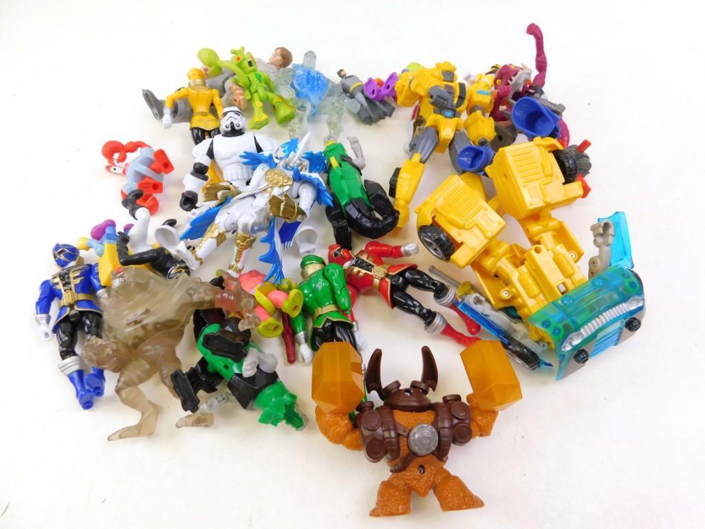 Large Lot of Action Figures: Large Lot of Action Figures Looks assorted. Some sort of Transforming robot car, a bat man figure, etc.