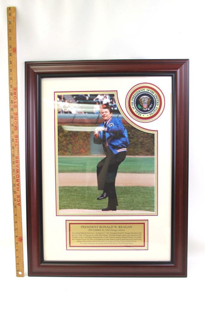 Framed Photo, Plaque and Presidential Seal of Ronald: Framed Photo, Plaque and Presidential Seal of Ronald Reagan Throwing out the first pitch at Wrigley Field wearing a Chicago Cubs Jacket. September 30th 1988. Apparently he wears dress shoes and a tie 