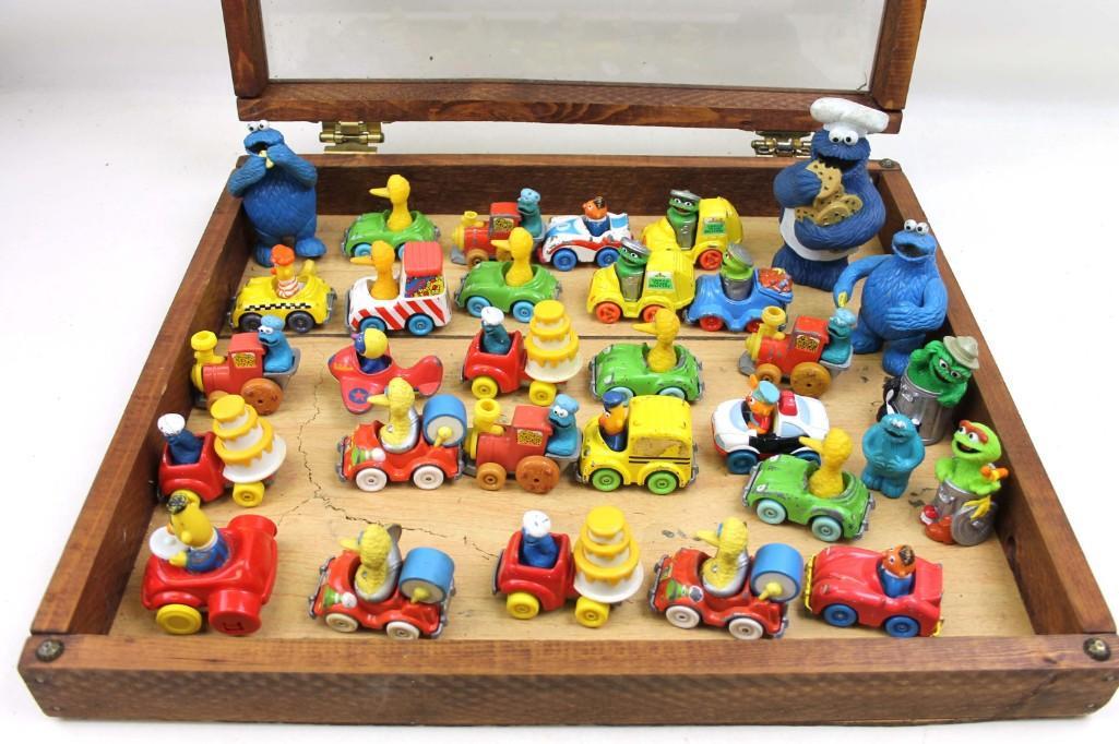 Lot of Sesame Street Toys incl Cars and Vehicles in a: Lot of Sesame Street Toys incl Cars and Vehicles in a Display Case Note: Display case is included if you want it. If you do NOT want it because it will be heavy to ship, please let us know