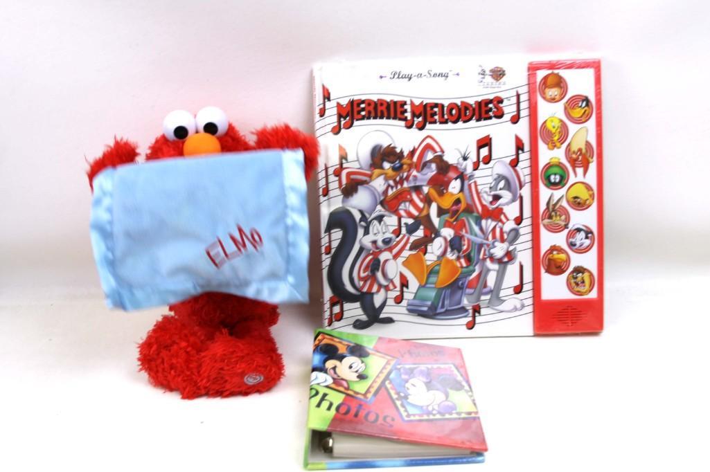 Plush Elmo , Warner Bros Merrie Melodies Book , Disney: Lot of toys including Plush Sesame Street Elmo , Warner Bros Merrie Melodies Book , Disney Photo Album