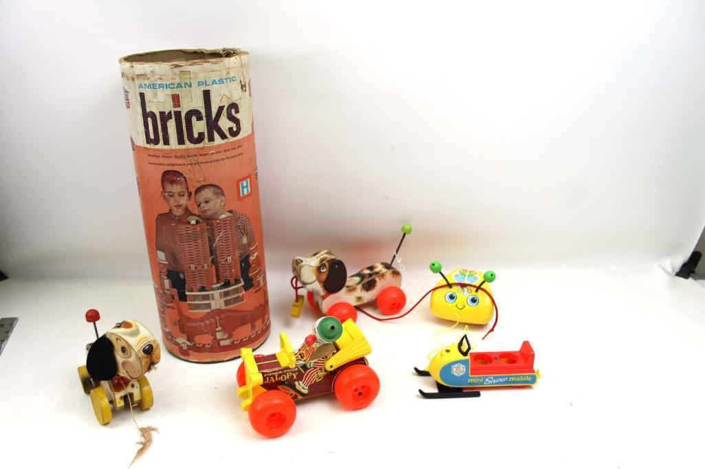 Lot of Vintage Pull Toys incl Fisher Price and American: Lot of Pull Toys incl Fisher Price and American Plastic Bricks . includes Jalopy , Mini Snow Mobile , Dogs , Tug a Bug , 