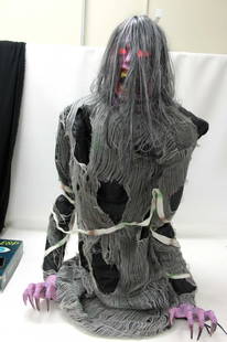 Animatronic Demonica Haunted House Prop Rises to 3 Ft: Halloween sound activated Halloween animated figure.&nbsp; She rises up from about 2 feet tall to about 3 feet tall while twisting and struggling, as if to come out of the grave .&nbsp; Her eyes light