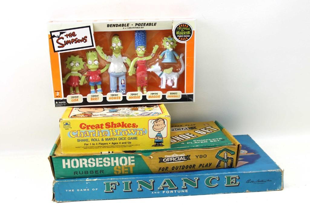Lot of Toys and Games incl The Simpsons Bendy Figures ,: Lot of Toys and Games incl The Simpsons Bendy Figures , Great Shakes Charlie Brown Game , The Game of Finance and Fortune , and a Rubber Horseshoe Set Condition: Games are unchecked for complete