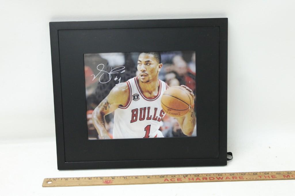 Framed Autographed Photo of Derrick Rose Chicago Bulls: Framed Autographed Photo of Derrick Rose Chicago Bulls No COA, but on the back is a picture of him presumably signing photos.