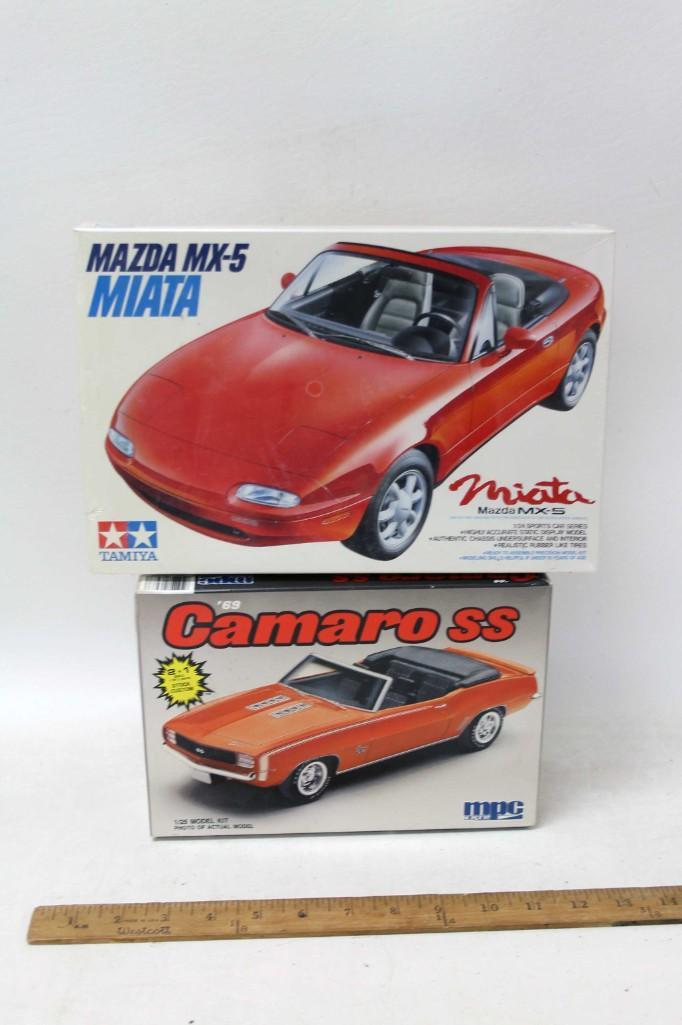 Lot of 2 Model Car Kits incl Tamiya Mazda Miata MX-5: Lot of 2 Model Car Kits incl Tamiya Mazda Miata MX-5 and MPC '69 Camaro SS . Miata is 1:24 Scale and is new and sealed . Camaro is 1:25 Scale and includes everything you see in the picture