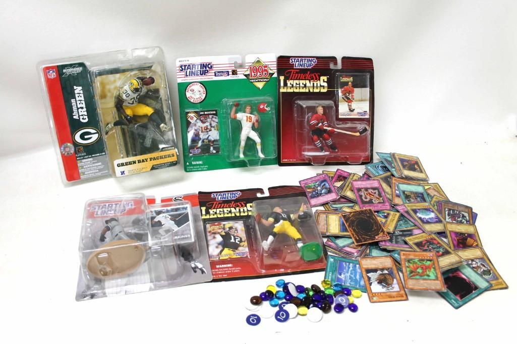 Lot of Starting Lineup Players and Yu-Gi-Oh Cards: Lot of Starting Lineup Players and Yu-Gi-Oh Cards Includes Ahman Green, Joe Montana, Bobby Hull, Terry Bradshaw, Tim Raines. Some of the Yu-Gi-Oh Cards have condition issues.