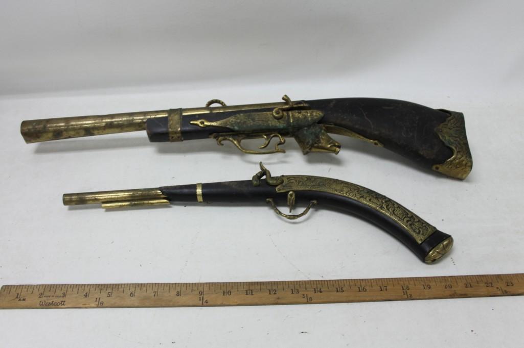 Lot of 2 Antique Brass Display Guns: Lot of 2 Antique Brass Display Guns Made in England. These are display pieces that don't work. The triggers aren't real, The have pieces built in for hanging on the wall, etc. One has a big head
