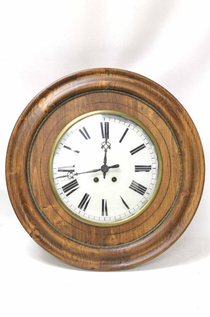 Vintage Windup Round Wall Clock with Key: Vintage Windup Round Wall Clock with Key Roughly 23" in diameter - it's big The back is octagon shaped and there is a big split in the wood on the back as shown in the pictures.The clock does not seem