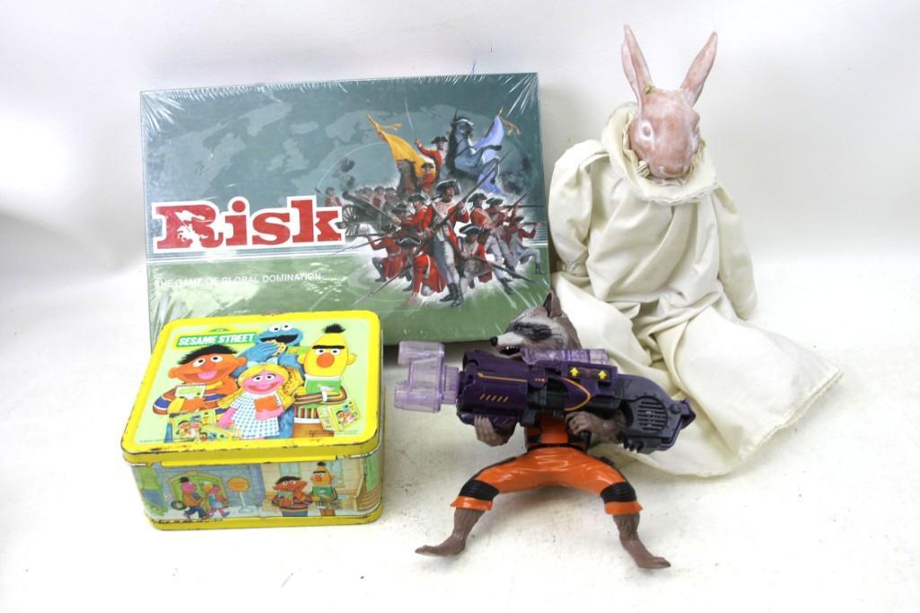 Toy Lot incl Sesame Street Metal Lunchbox , Risk Game ,: Toy Lot incl Sesame Street Metal Lunchbox , Risk Game New and Sealed , Marvel Guardians of the Galaxy Rocket Raccoon Action Figure , Decorative Rabbit with a chipped ear Condition: Risk is New and sea