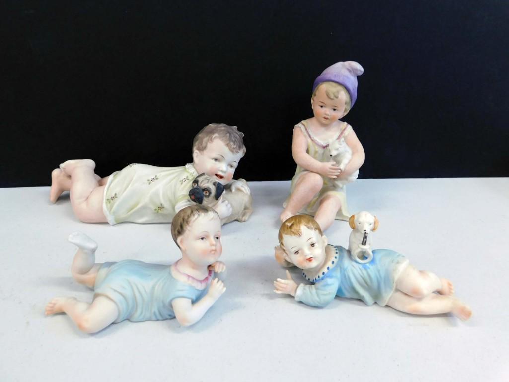 4 Porcelain Piano Babies: Lot of 4 Porcelain Piano Babies Condition: The one with the pug has a crack in the bend of it's leg