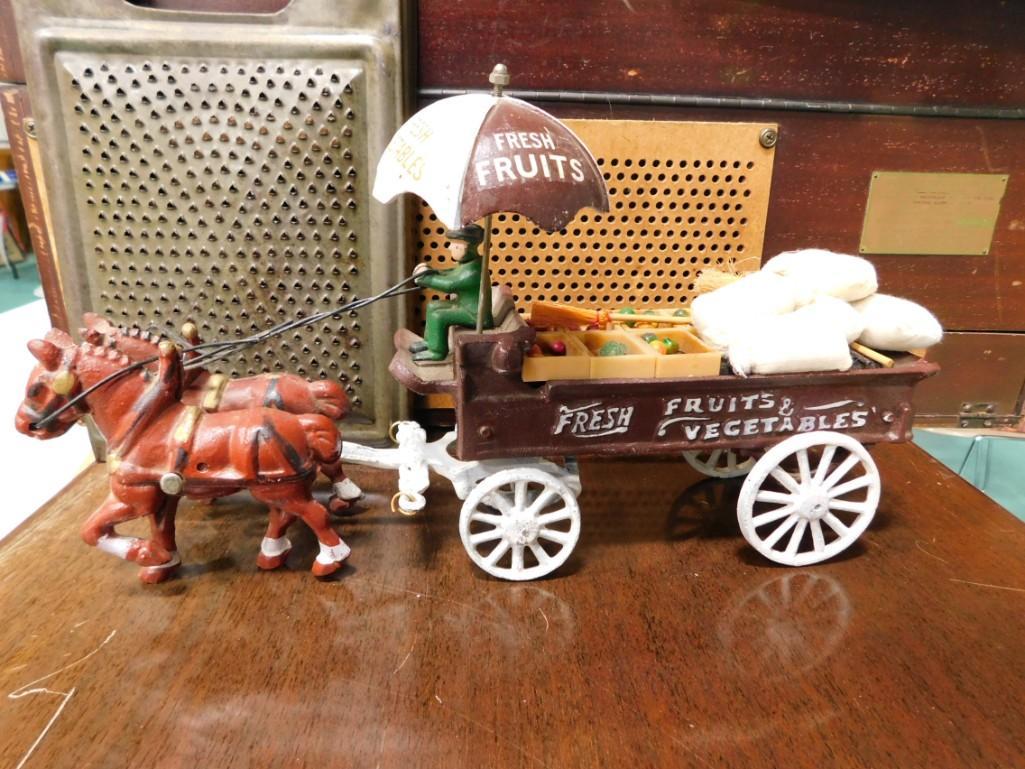 Cast Iron Grocery Wagon with Horses and Antique Cheese Grager: Cast Iron Grocery Wagon with Horses and Antique Cheese Grater Condition: Cast iron wagon appears to be a vintage reproduction. Glue has come loose on the little fruits and baskets and accessories so t