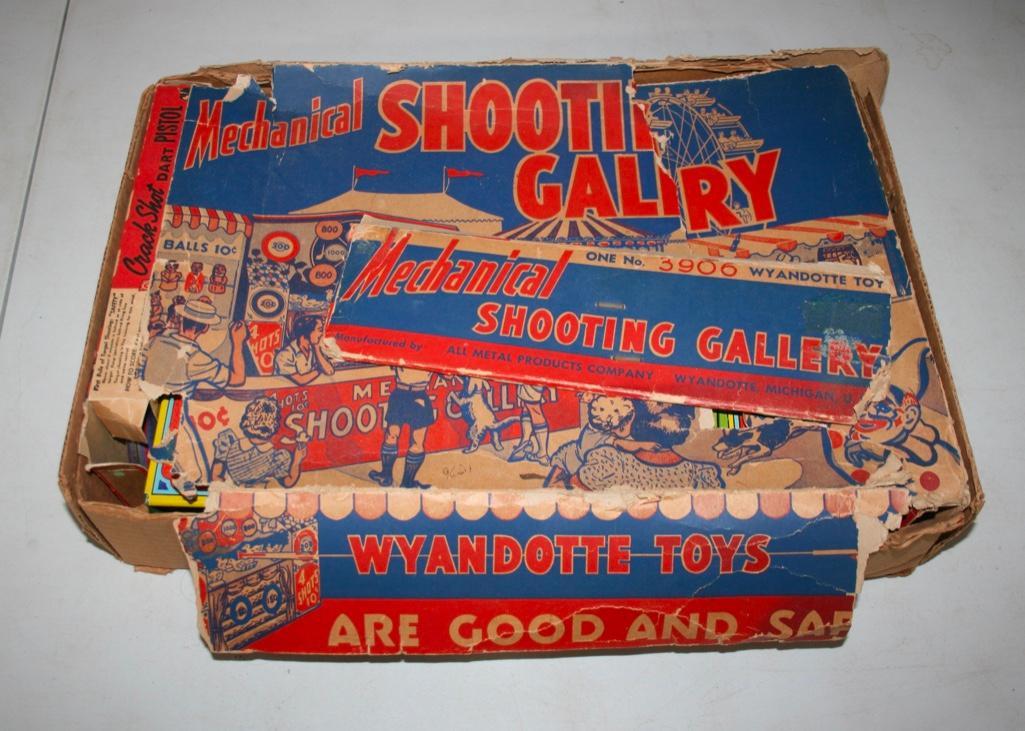 Shooting Gallery - All Metal Products Company: Shooting Gallery - All Metal Products Company We think this is from the 1950's. Has two guns, two darts, and the wind up key. You can see the original box exhibits significant wear. We did not tes