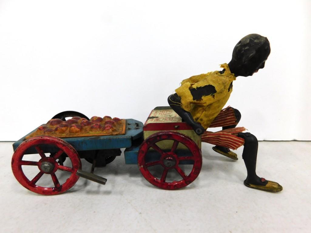 Vintage Black Americana Wind Up Toy Works: Vintage Black Americana Wind Up Toy Man on a Cart Works . His clothes have tears and stains