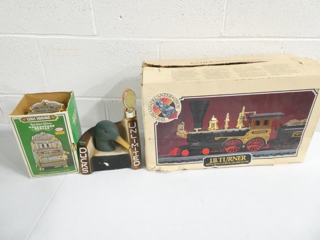 Decanters incl Train Locomotive Grant 1872, Ezra Brooks Slot Machine Decanter, Ducks Unlimited Decan: Decanters incl Train Locomotive Grant 1872, Ezra Brooks Slot Machine Decanter, Ducks Unlimited Decanter . These are all empty. Train Smokestack is open on the top/probably missing a cap of some sort