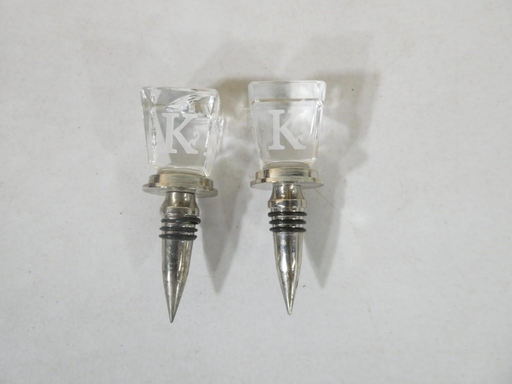 2 Glass Wine Bottle Stoppers "K": 2 Glass Wine Bottle Stoppers "K" . Condition: 1 has a crack on the top