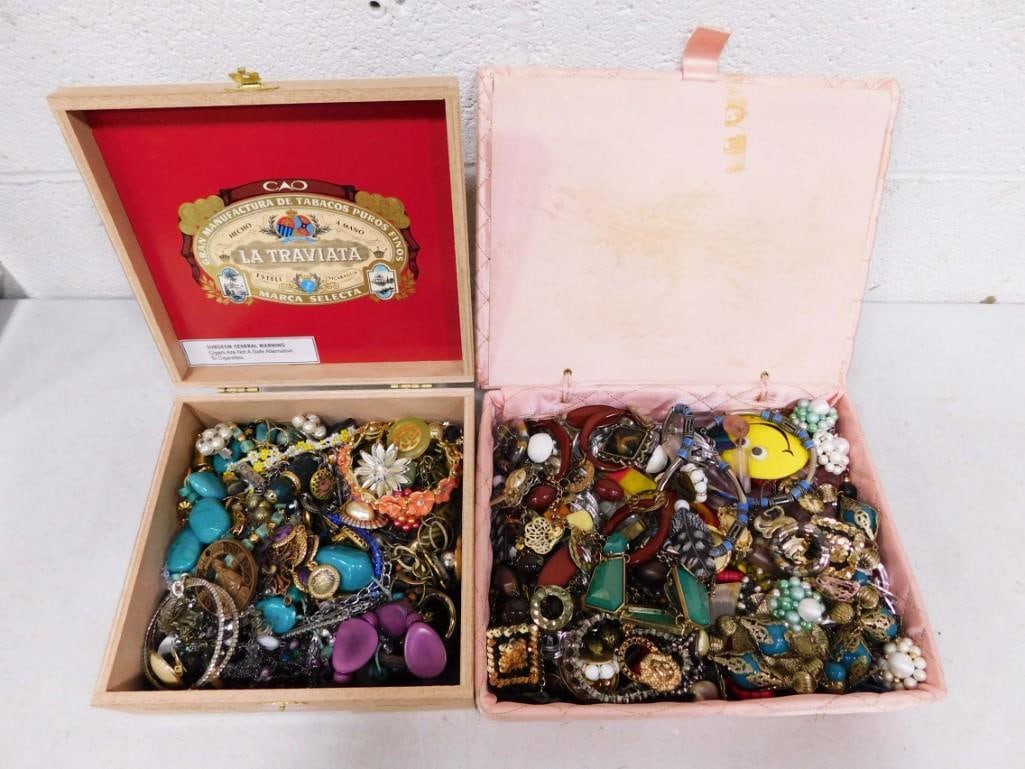 Lot of Costume Jewelry: Lot of Costume Jewelry Jewelry is in a cigar box and a pink quilted box. Pink quilted box is in rough condition.