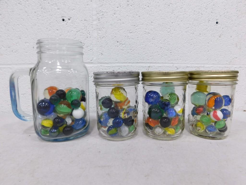Lot of Marbles in Jars and a Glass Mug: Lot of Marbles in Jars and a Glass Mug
