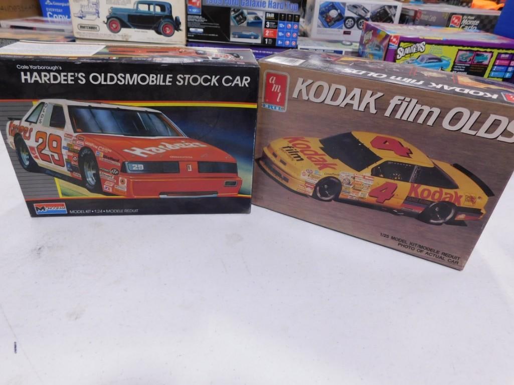 2 Model Car Kits incl Monogram Cale Yarborough's Hardee's Oldsmobile Stock Car and AMT Ertl Kodak: 2 Model Car Kits incl Monogram Cale Yarborough's Hardee's Oldsmobile Stock Car 1:24 Scale and AMT Ertl Kodak Film Olds 1:25 Scale. Both in open boxes. Includes everything that you see in the p