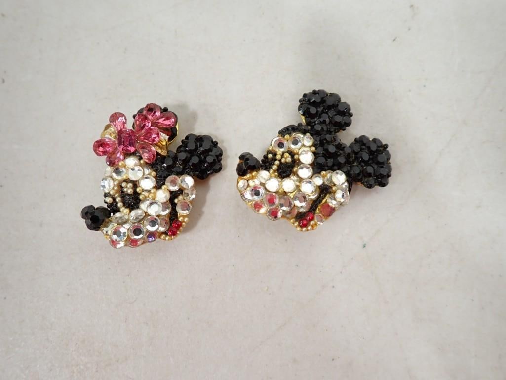 A Pair of Wendy Gell Disney Mickey and Minnie Earclips: A Pair of Wendy Gell Disney Mickey and Minnie Earclips. Crystal earclips are both stamped "Wendy Gell Disney Co"- Mickey is missing a stone, but Minnie is okay.