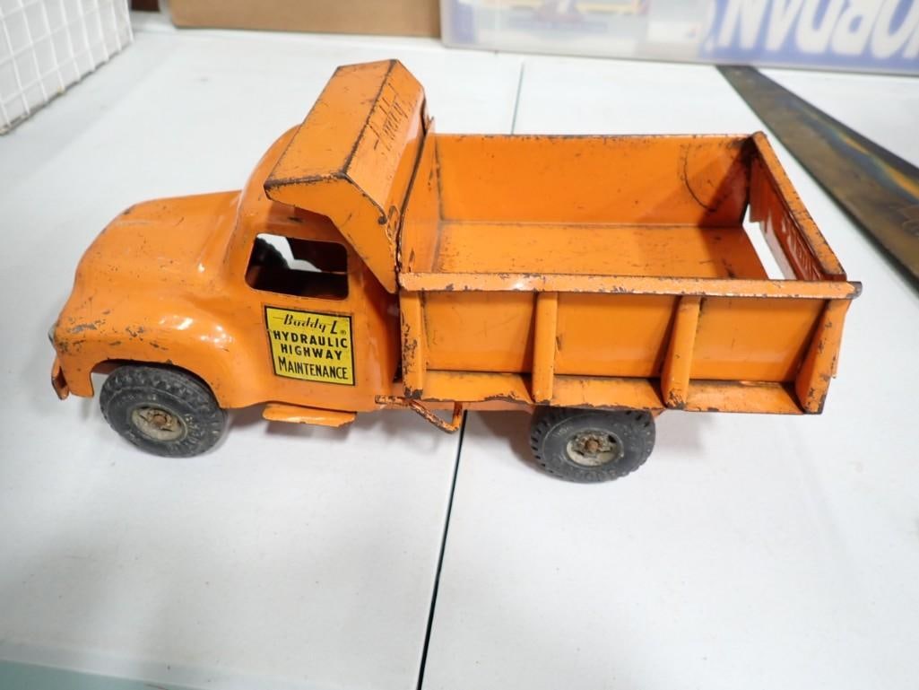 Buddy L Pressed Steel Dump Truck with Spring Dumper Works Orange: Buddy L Pressed Steel Dump Truck with Spring Dumper Works Orange . Approximately 14" long