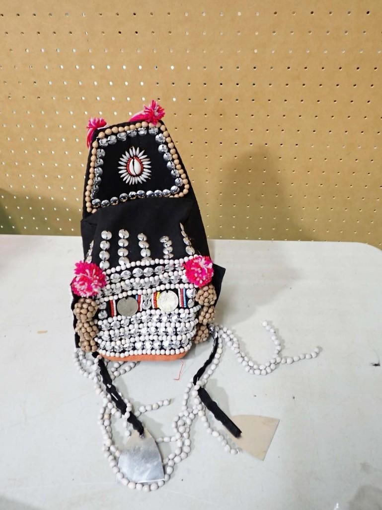 A Thai Akha Headdress: A Thai Akha Headdress . Black cotton headdress decorated with shells, beads, coins, yarn, and metal