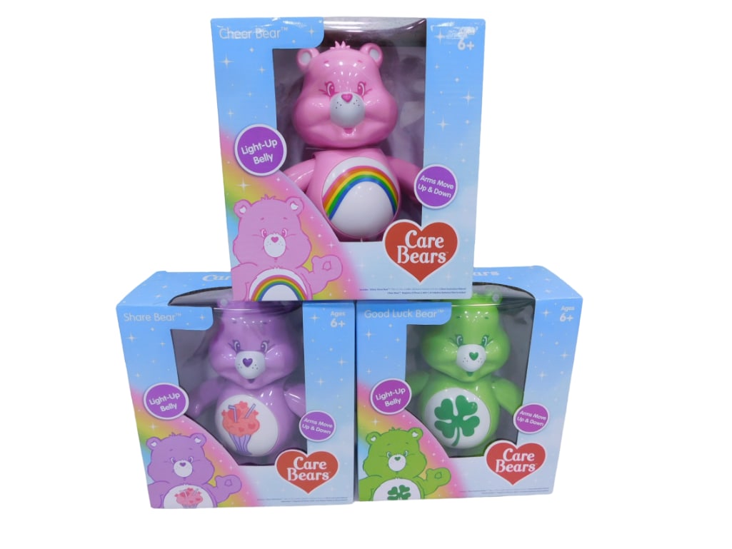 3 Care Bears Toys New in Boxes with Light Up Bellies and Moving Arms: 3 Care Bears Toys new in boxes. Each has a light-up belly and arms that move up and down. Includes Cheer Bear, Share Bear, Good Luck Bear.