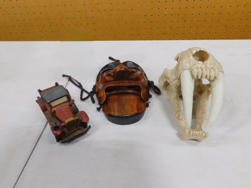 Misc. Lot including Wooden Model Car, Wooden Mask, Plastic Saber Tooth Skull: Misc. Lot including Wooden Model Car, Wooden Mask, Plastic Saber Tooth Skull 9x6x5" Live Auctioneers is now offering Live Shipping through them.? This is an optional payment/shipping system.? If y