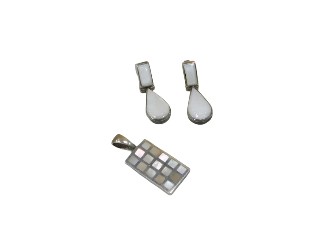 Sterling silver and mother-of-pearl jewelry; rectangular mosaic pendant (H: 1.5") and pair of drop e: Sterling silver and mother-of-pearl jewelry; rectangular mosaic pendant (H: 1.5") and pair of drop earrings Wt: 9.8 dwt Live Auctioneers is now offering Live Shipping through them. This is an op