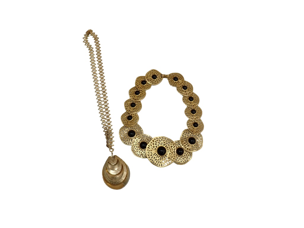 Two goldtone metal necklaces; Sarah Coventry link necklace with openwork pear shaped pendant. Signed (1 of 9)