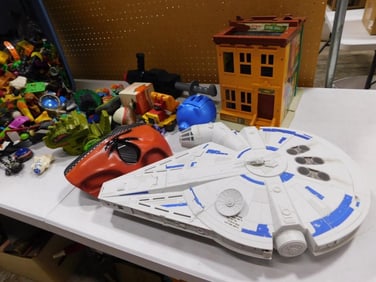 Bin full of assorted Toys including Star Wars Millennium Falcon, Fisher Price Sesame Street Hooper's