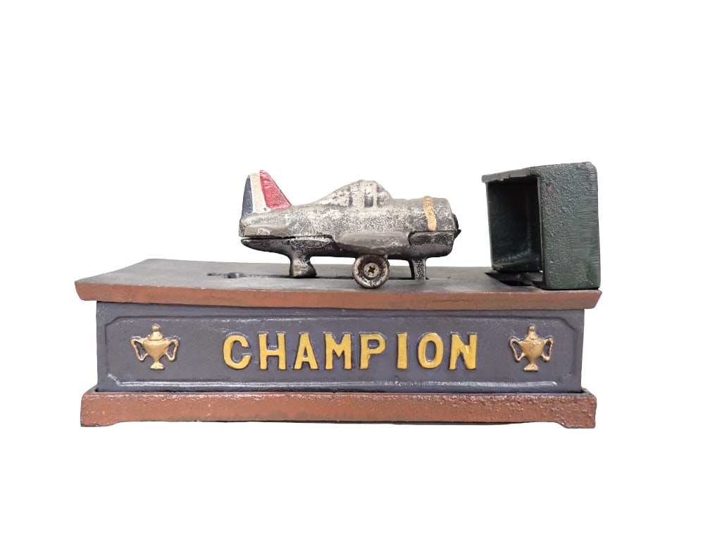 Cast Iron Airplane Mechanical Bank Champion: Champion Airplane or Plane Cast Iron Mechanical Coin Bank 8"x4"x5" All pictures are considered part of the description and should be examined carefully by bidders. Live Auctioneers is now 