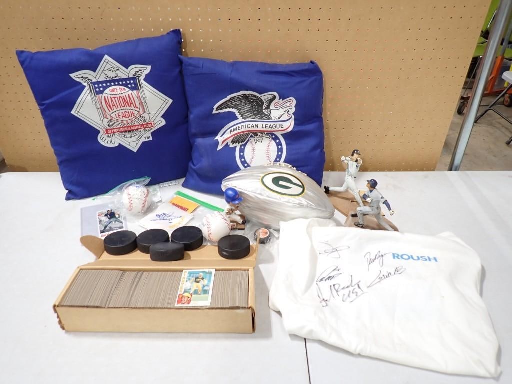 Sports lot including Baseball Pillows, Autographs (No COAs), Figurines, Hockey Pucks, Green Bay Pack: Sports lot including Baseball Pillows, Autographs (No COAs), Figurines, Hockey Pucks, Green Bay Packers Football, 1984 Baseball Cards 17x17x2" All pictures are considered part of the descrip