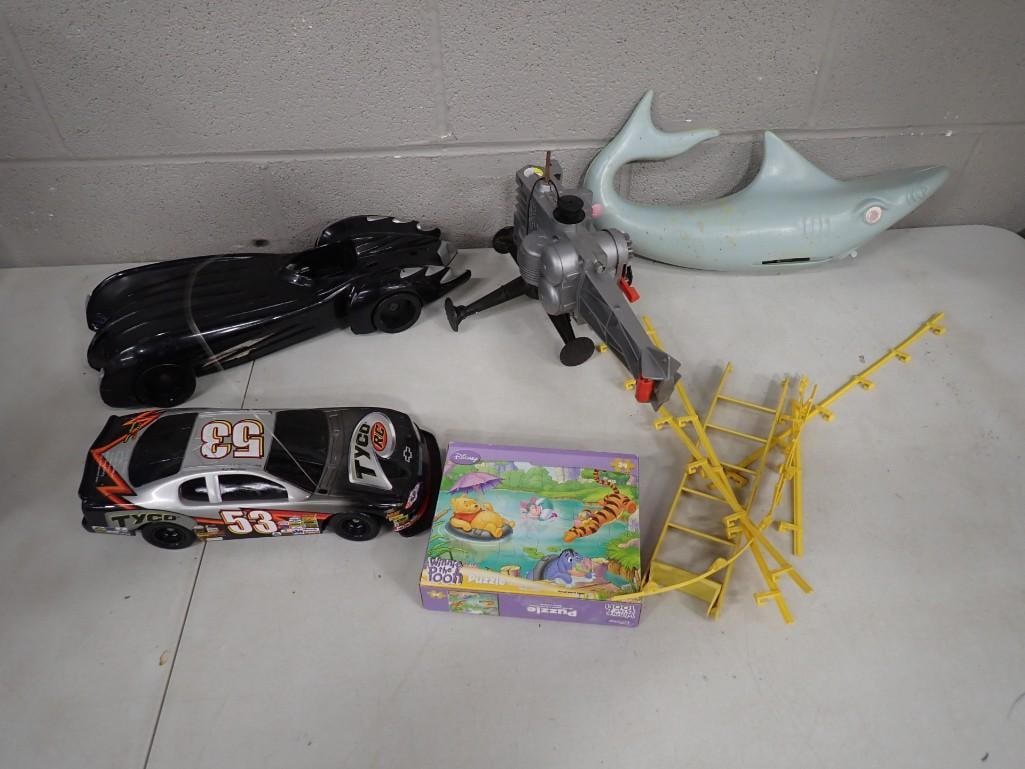 Assorted TOy Lot including Walt Disney Winnie the Pooh Puzzle, Batmobile, Shark, Car, etc.: Assorted TOy Lot including Walt Disney Winnie the Pooh Puzzle, Batmobile, Shark, Car, etc. All pictures are considered part of the description and should be examined carefully by bidders. Live Auction