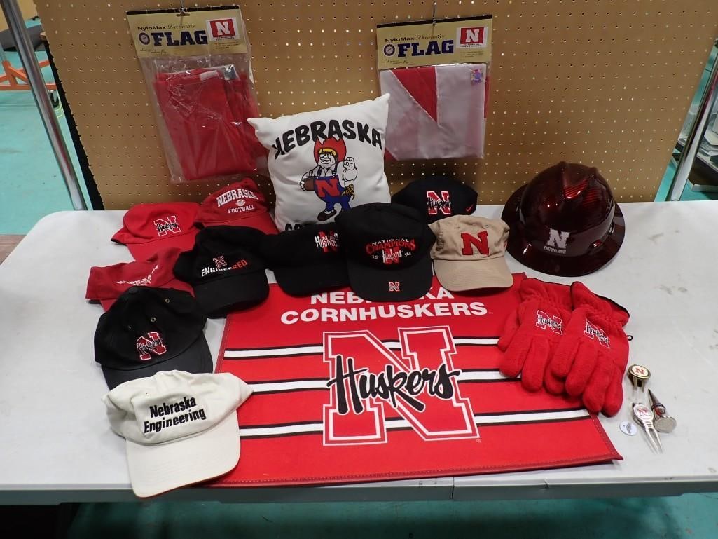 Lot of Univ of Nebraska Cornhuskers Hats, Rug, Flag, Wine Stopper, Pillow, and More: Lot of University of Nebraska Cornhuskers Hats, Rug, Flag, Wine Stopper, Pillow, and More All pictures are considered part of the description and should be examined carefully by bidders. Live Auctio
