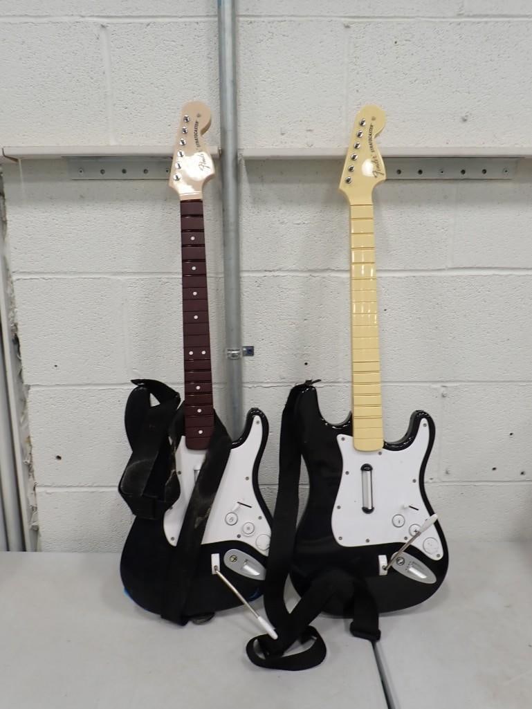 Pair of Rockband Guitars - Harmonix and Rockband 4: Pair of Rockband Guitars - Harmonix and Rockband 4. Fender Stratocaster style. All pictures are considered part of the description and should be examined carefully by bidders. Live Auctioneers is now