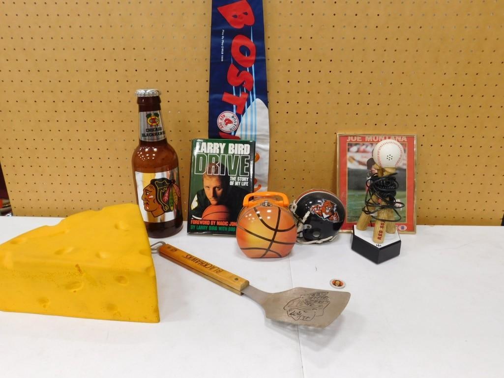 Sports Lot including Cheesehead Hat, Blackhawks Spatula, Larry Bird Book, Basketball Case, Mini Helm (1 of 6)