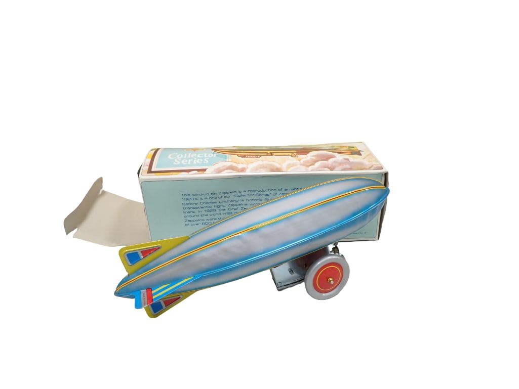 Vintage Zeppelin Collector Series Wind Up Tin Toy Made in Korea with Original Box: Vintage Zeppelin Collector Series Wind Up Tin Toy Made in Korea with Original Box All pictures are considered part of the description and should be examined carefully by bidders. Live Auctioneers is n