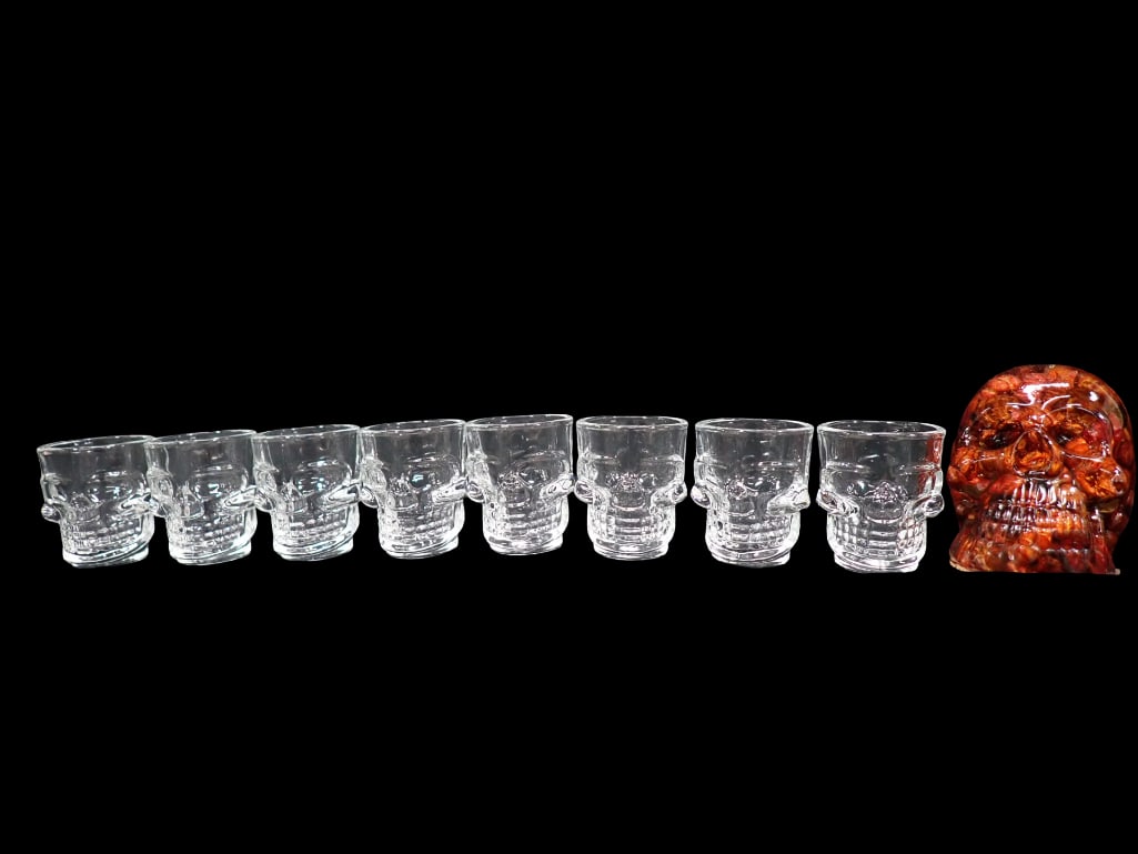 8 Glass Skull Shot Glasses and 1 Resin Skull Filled with Small Pumpkins: 8 Glass Skull Shot Glasses and 1 Resin Skull Filled with Small Pumpkins All pictures are considered part of the description and should be examined carefully by bidders. Live Auctioneers is now offerin