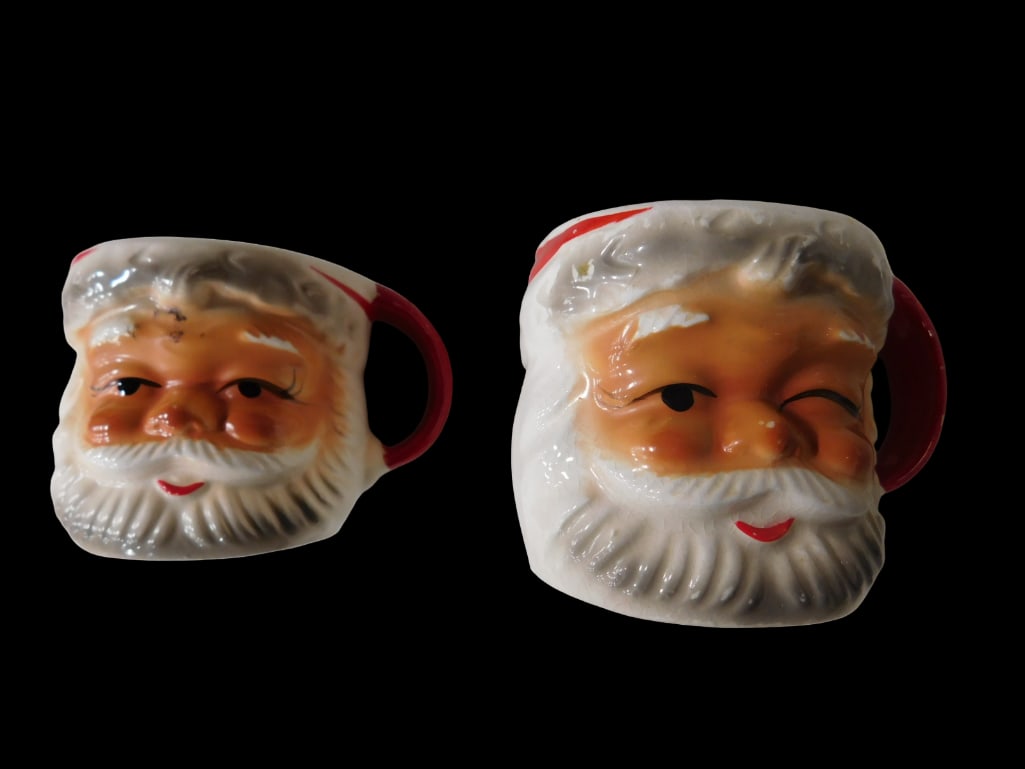 2 Vintage Santa Mugs incl 1 Winking: 2 Vintage Santa Mugs including 1 Winking. All pictures are considered part of the description and should be examined carefully by bidders. Live Auctioneers is now offering Live Shipping through them.