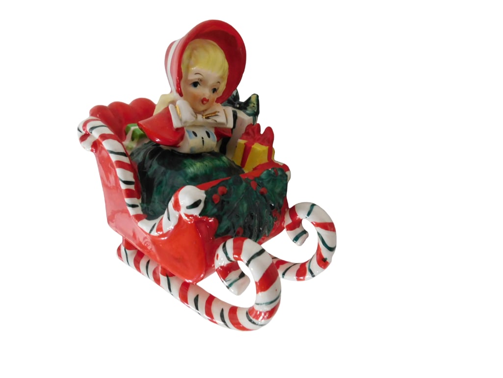 Vintage Lefton Christmas Shopper Girl in Candy Cane Sleigh, Runner Broken: Vintage Lefton Christmas Shopper Girl in Candy Cane Sleigh, Runner Broken. All pictures are considered part of the description and should be examined carefully by bidders. Live Auctioneers is now offe