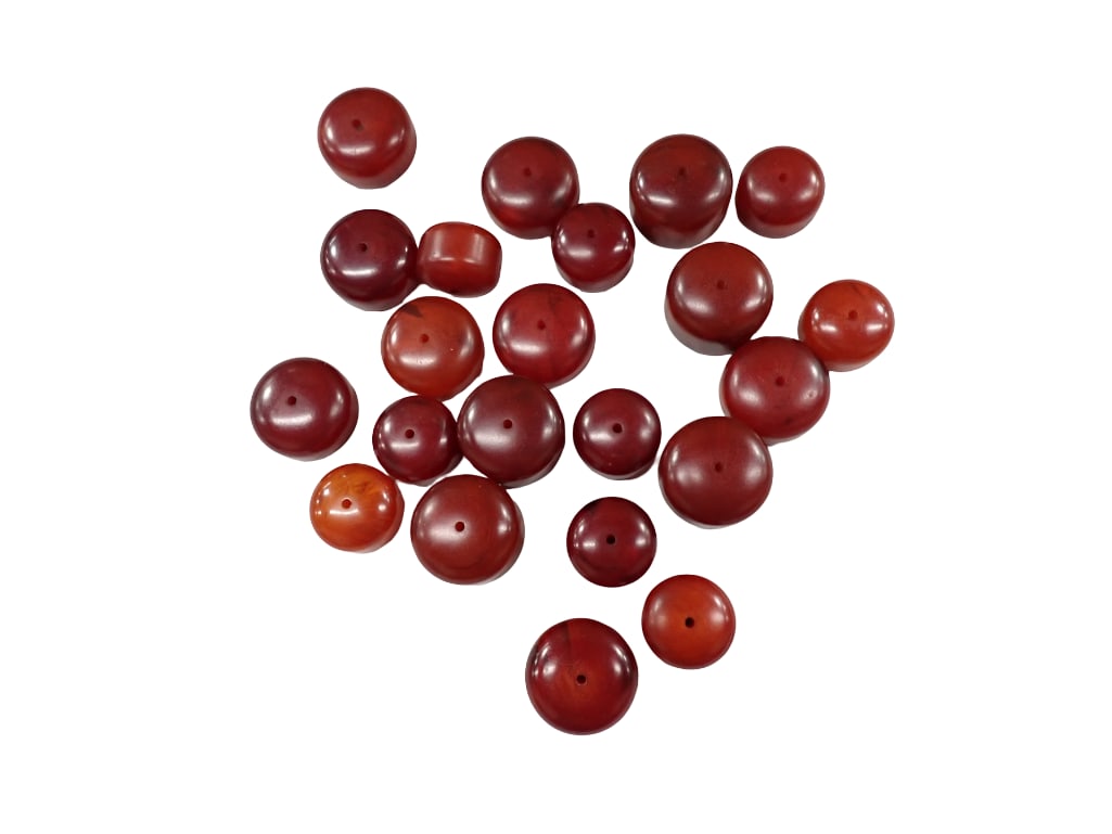 Lot of Red Beads - believed to be Lucite. There are about 22 beads: Lot of Red Beads - believed to be Lucite. There are about 22 beads and the beads are between about 18 and 35 grams each. The beads show marbling when held to a flashlight. All pictures are considered 