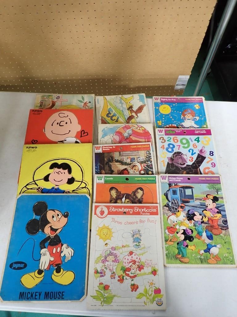 Lot of Frame Tray Puzzles incl Strawberry Shortcake, Mickey Mouse, The Peanuts Lucy and Charlie Brow: Lot of Vintage Frame Tray Puzzles incl Strawberry Shortcake, Mickey Mouse, The Peanuts Lucy and Charlie Brown, Raggedy Ann, Lassie, etc All pictures are considered part of the description and should b