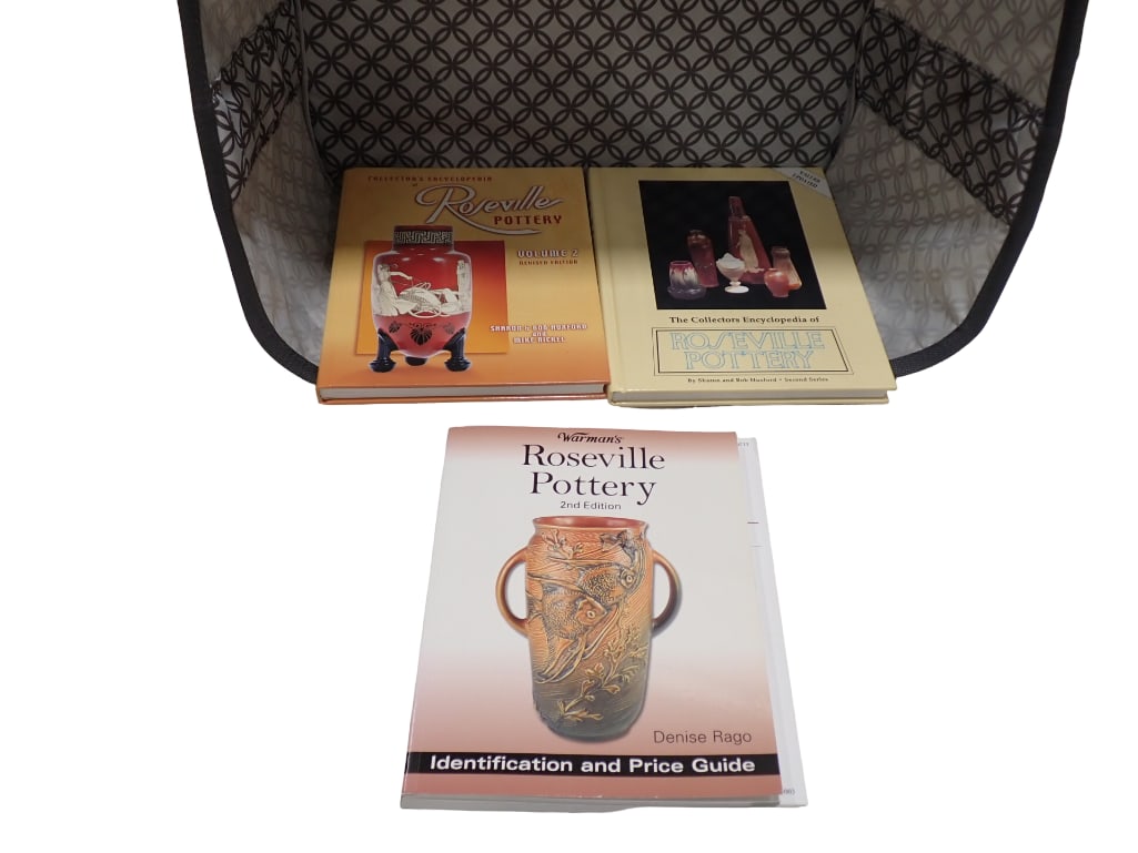 Roseville Pottery Collectors Books and a Basket: Roseville Pottery Collectors Books and a Basket All pictures are considered part of the description and should be examined carefully by bidders. Live Auctioneers is now offering Live Shipping throug