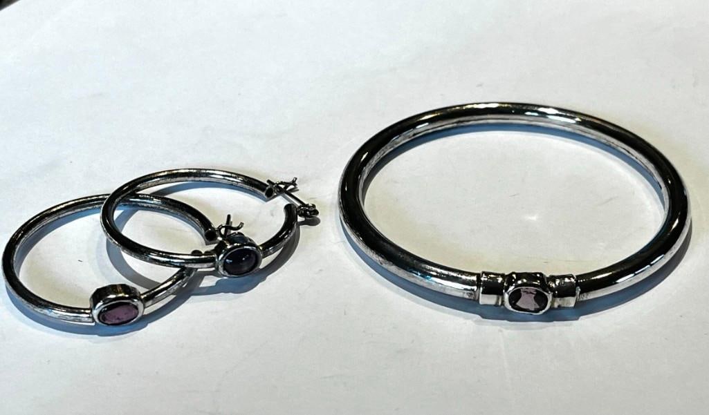 Sterling Silver and Amethyst Bangle Bracelet and matching Pierced Earrings: Sterling silver and amethyst bangle bracelet and matching pierced earrings 20 grams total weight All pictures are considered part of the description and should be examined carefully by bidders.
