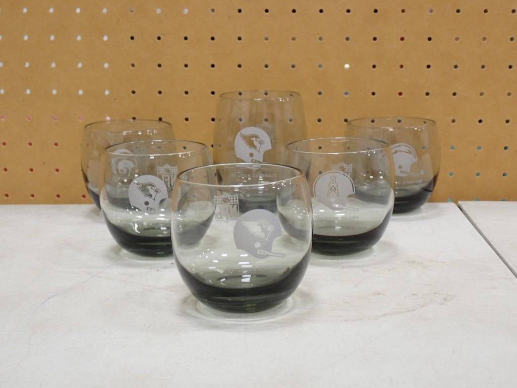 5 NFL Football Smoked Glass Roly Poly Bar Glasses and 1 Larger St Louis Cardinals Bar Glass: 5 NFL Football Smoked Glass Roly Poly Bar Glasses and 1 Larger St Louis Cardinals Bar Glass All pictures are considered part of the description and should be examined carefully by bidders. Live