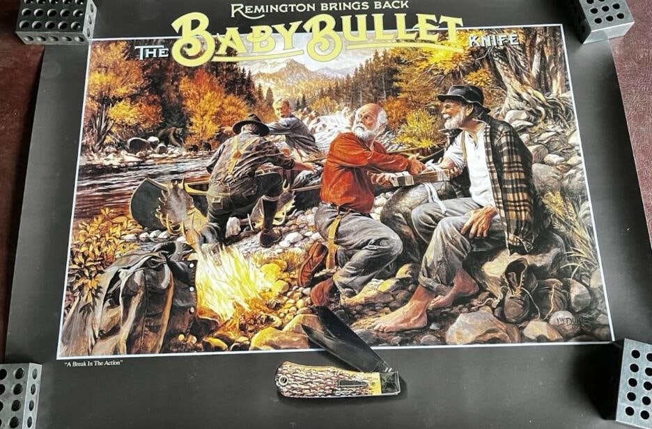 Remington Baby Bullet Knife "A Break in the Action" 1996 Poster: Remington baby bullet knife "a break in the action" 1996 poster - new old stock, 20" x 26" All pictures are considered part of the description and should be examined carefully by bidd