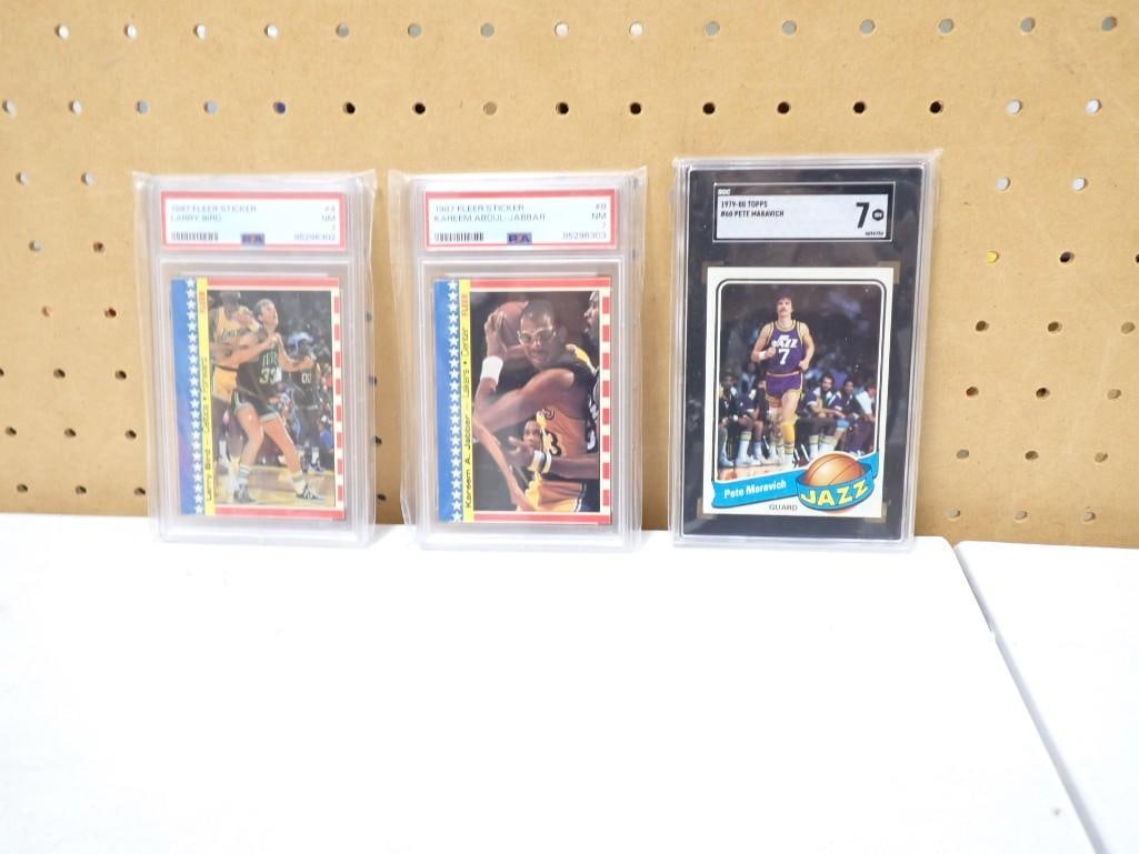 3 Graded Basketball Cards incl 1987 Kareem Sticker PSA 7, 1987 Bird Sticker PSA 7, 1979-80 Pete (1 of 3)